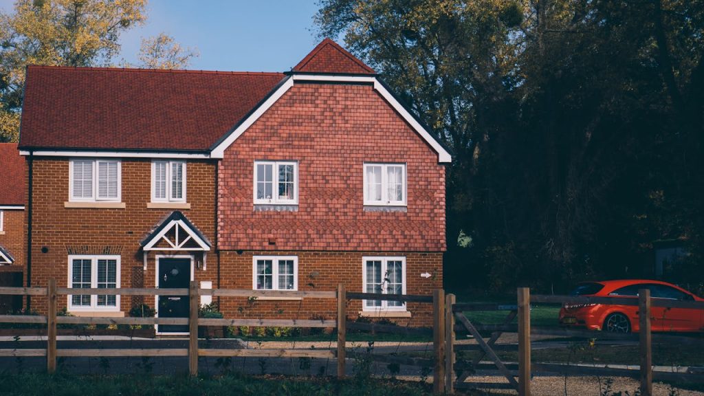 Quaint English family home with red brick and car in Farnham