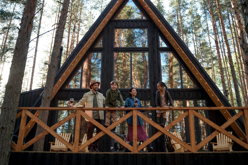 pexels-photo-9222068-9222068 A family enjoys their vacation at a modern A-frame cabin nestled in a peaceful forest setting.